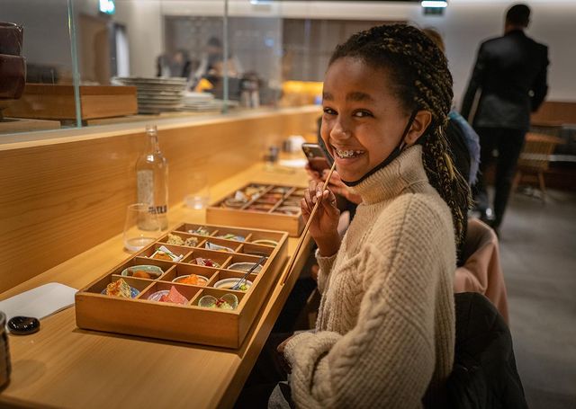 Naomi Kunken is a nude turtle-neck sweater.